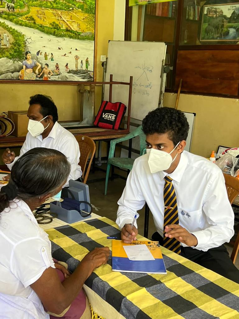 A Hearts for the Homeless volunteer taking a patient's blood pressure at a community screening in Venezuela